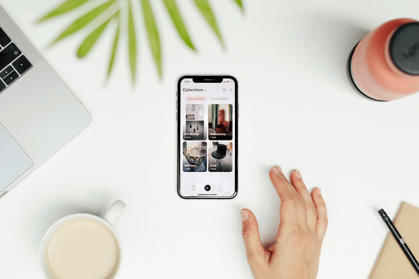 Photo of a desk with someone using the app in a phone